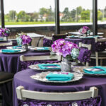 teal and pink plate set up with pink, purple and blue flowers and purple tables