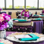 pink, purple, blue and teal table set up with flowers