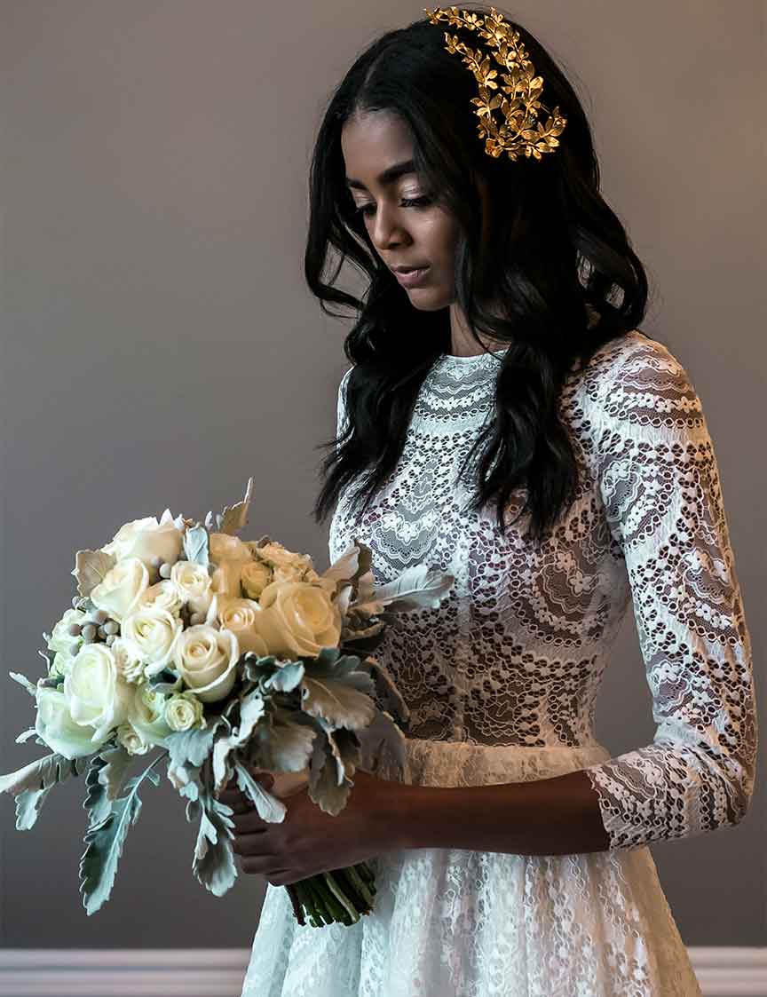 bride in white dress holding flowers