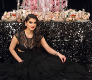 Glam night photoshoot black dress and pink backdrop