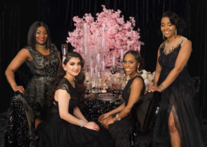 pink glam night group picture with decor table and pink flowers