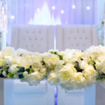 wedding stage with flowers backdrop white couch