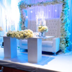 wedding stage with white flowers backdrop white couch