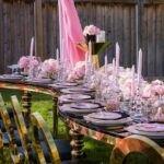 pink drapes, pink and gold theme, gold and black chairs, pink white purple roses, pink candles, outdoor event, main table, presentation